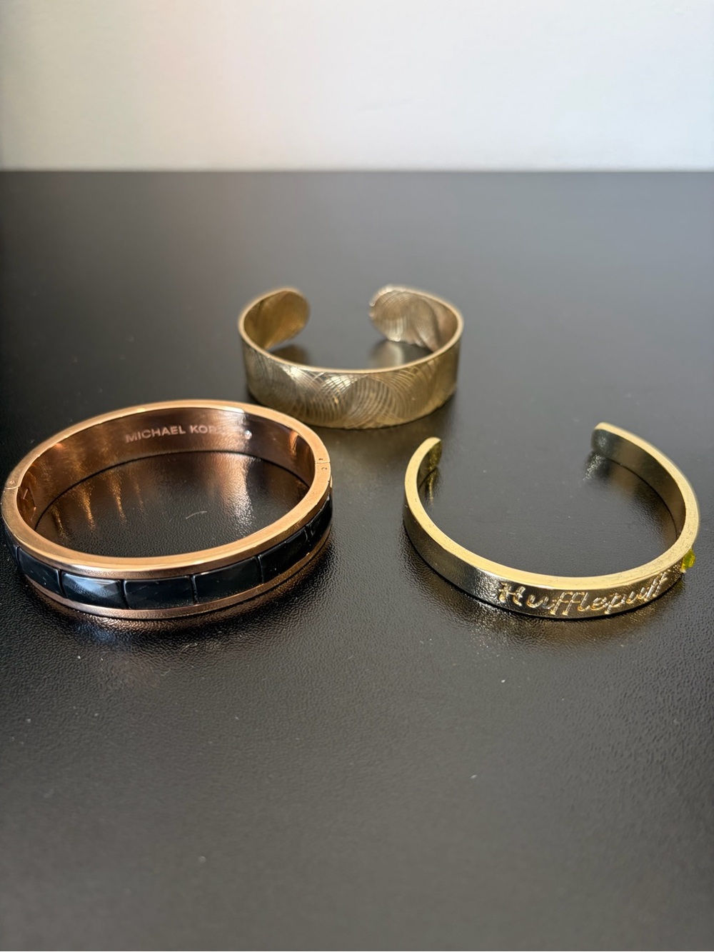 3 Bracelets including Michael Kors Gold Tone and Black Bangle Bracelet